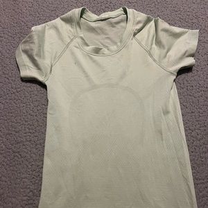Light sage green lululemon swiftly tech shirt in a size 2 one small stain